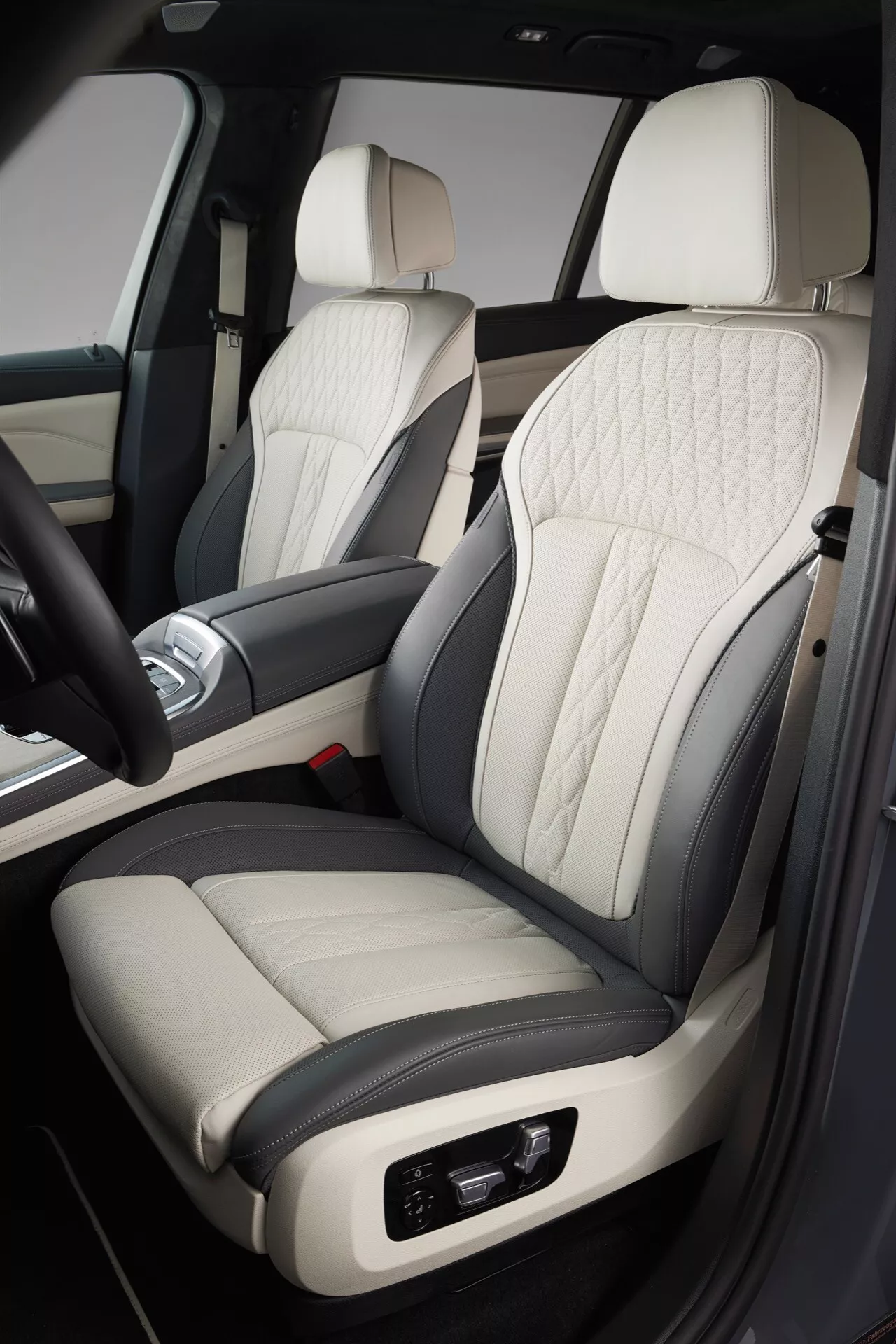 Detaljerad vy av interiören i BMW X7 2022 (G07-facelift), med fokus på passagerarsätet i premium tvåtonigt läder med quiltat diamantmönster, elektroniska justeringar, matchat med en lyxig dörr- och mittkonsoldesign