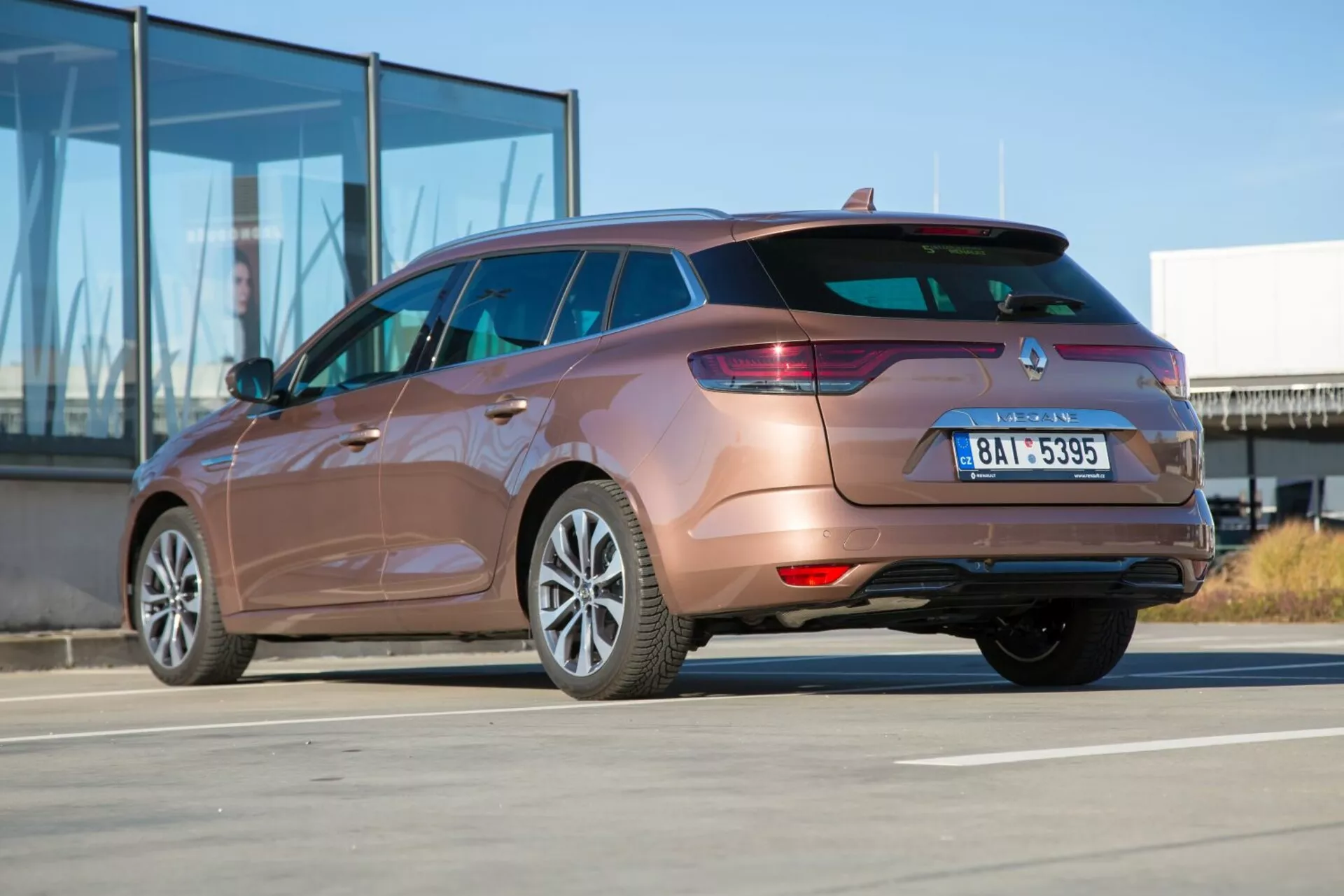 2009 års Kia Ceed-stationvagn fångad från ett bakre tredjedels vinkel som framhäver baklyktor, bakre stötfångardesign, avgasrör och sidokroppens konturer på en solig dag