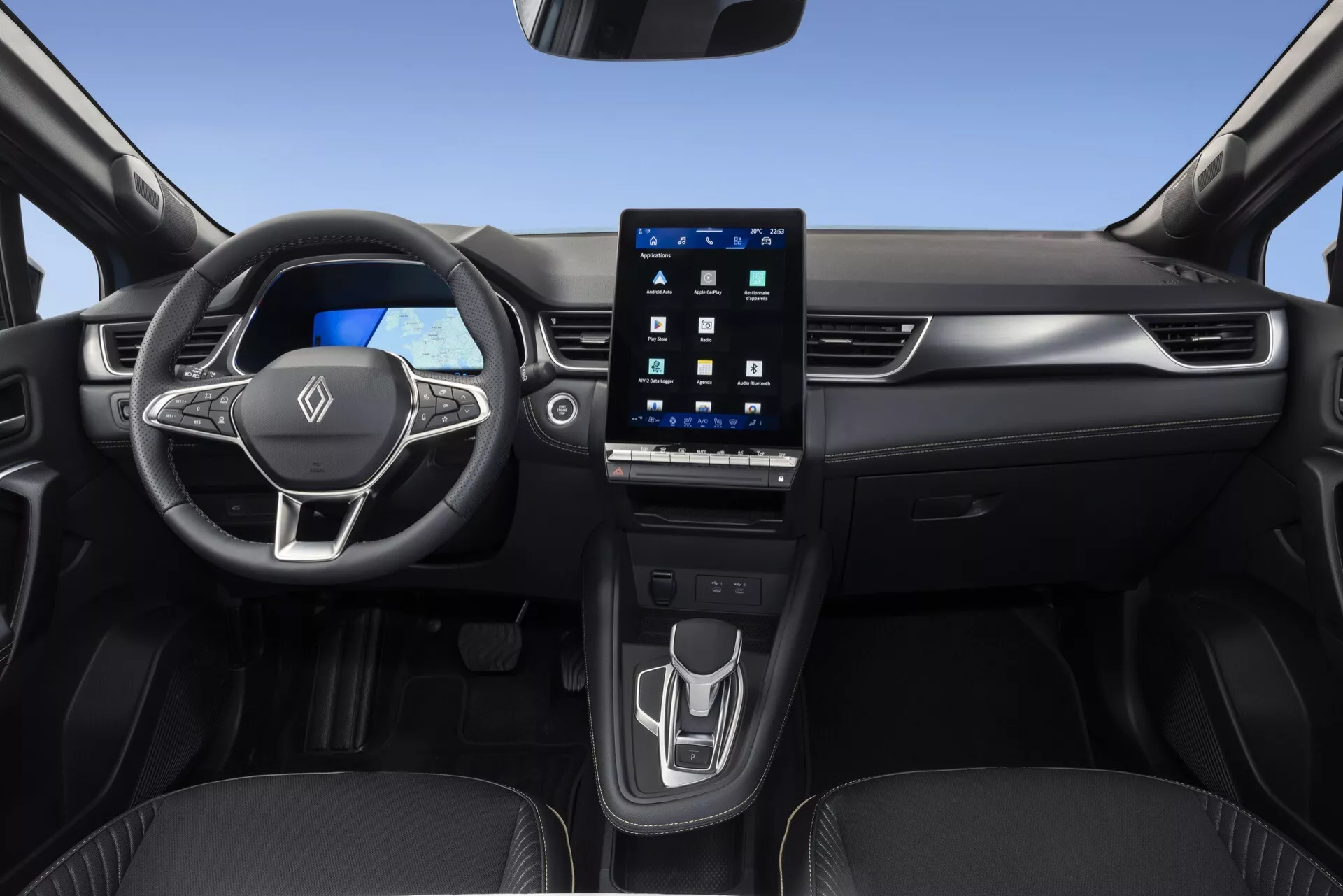 Interiörvy av Renault Symbioz 2024 från framsätet på passagerarsidan, som visar en multifunktionell treekrad ratt med inbyggda kontroller, en ljus digital instrumentpanel och en stor, porträttorienterad infotainmentskärm integrerad i mittkonsolen. Den rena och moderna mittkonsolen inkluderar en minimalistisk beröringskänslig kontrollpanel för klimatanpassningar och en modern elektronisk växelväljare, tillsammans med synliga mugghållare. Fordonet har en elegant design med högkvalitativa material och harmoniserade dörrpaneler, med fokus på avancerad fordonsteknik, digitala mätare och användarvänlighet.