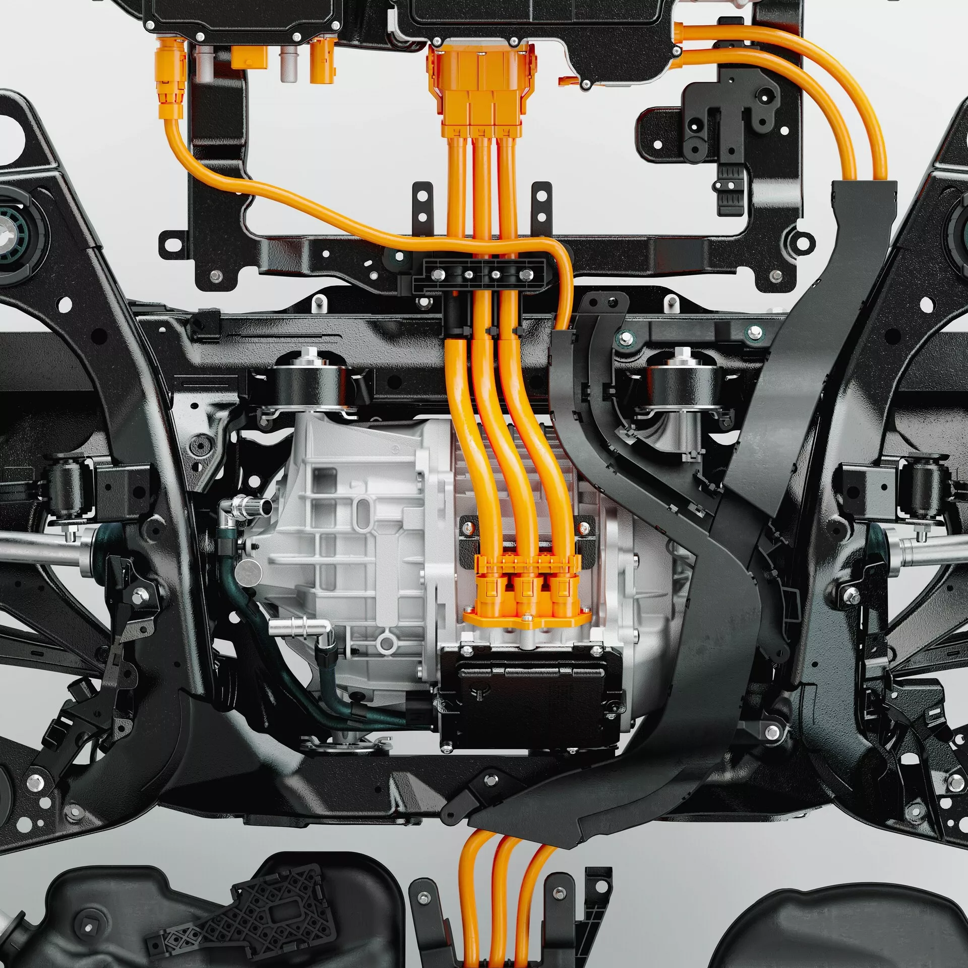 Närbild av underredet på en Volvo XC60 2021 (2:a generationens facelift) som framhäver de elektriska drivkomponenterna och chassit. Bilden, fotograferad från en nedåtgående vinkel, visar ett stort elektriskt motorhus med kylflänsar i mitten, starkt orange högspänningskablar och upphängningskomponenter som kontrollarmar. Kabelns placering antyder anslutning till ett centralt placerat batteripaket. Synliga delar av chassit och subramen ger monteringspunkter för drivlinan och upphängningen, vilket visar avancerade elektriska drivsystem och högspända elsystem.