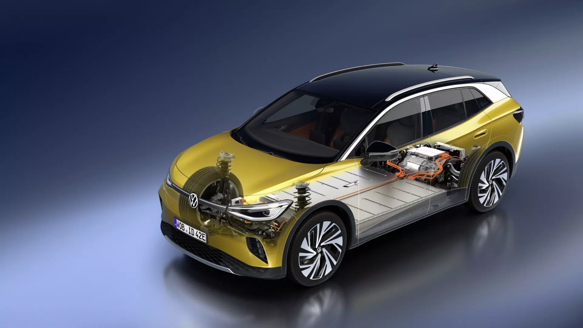2020 VW ID.4 1: a generationen visar dubbelvy av det eleganta exteriören i gult med svart tak och halvexponerad elektrisk drivlina inklusive batteripaket och motor